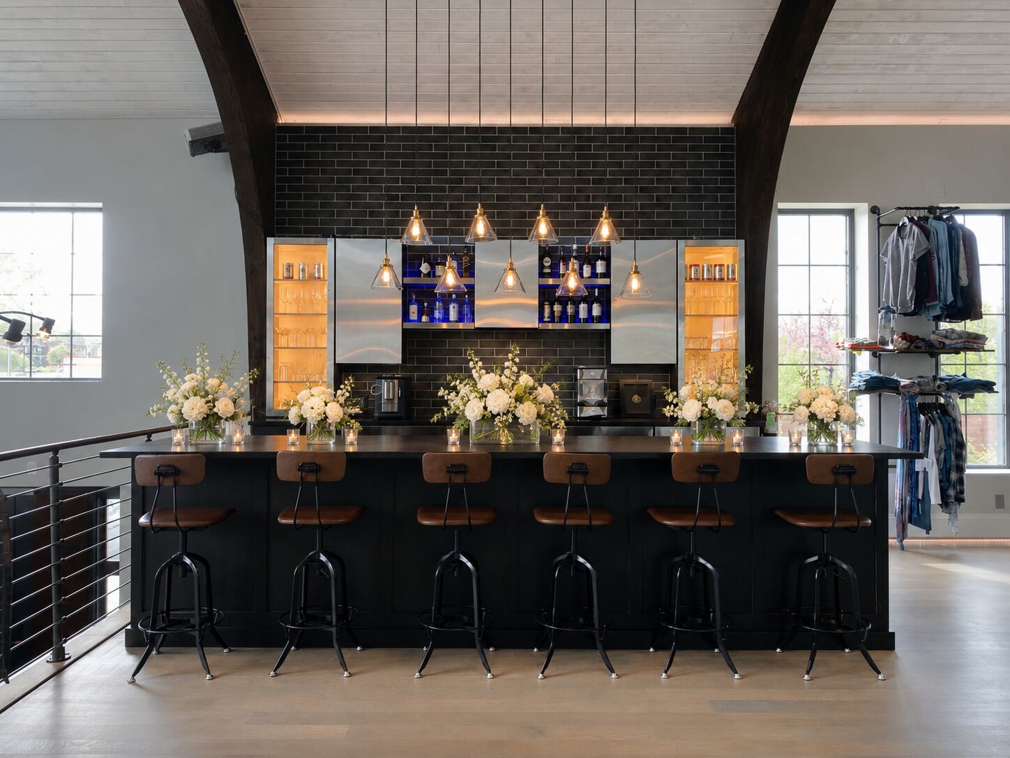 Black bar with pendant lighting and floral arrangements at THE 1301