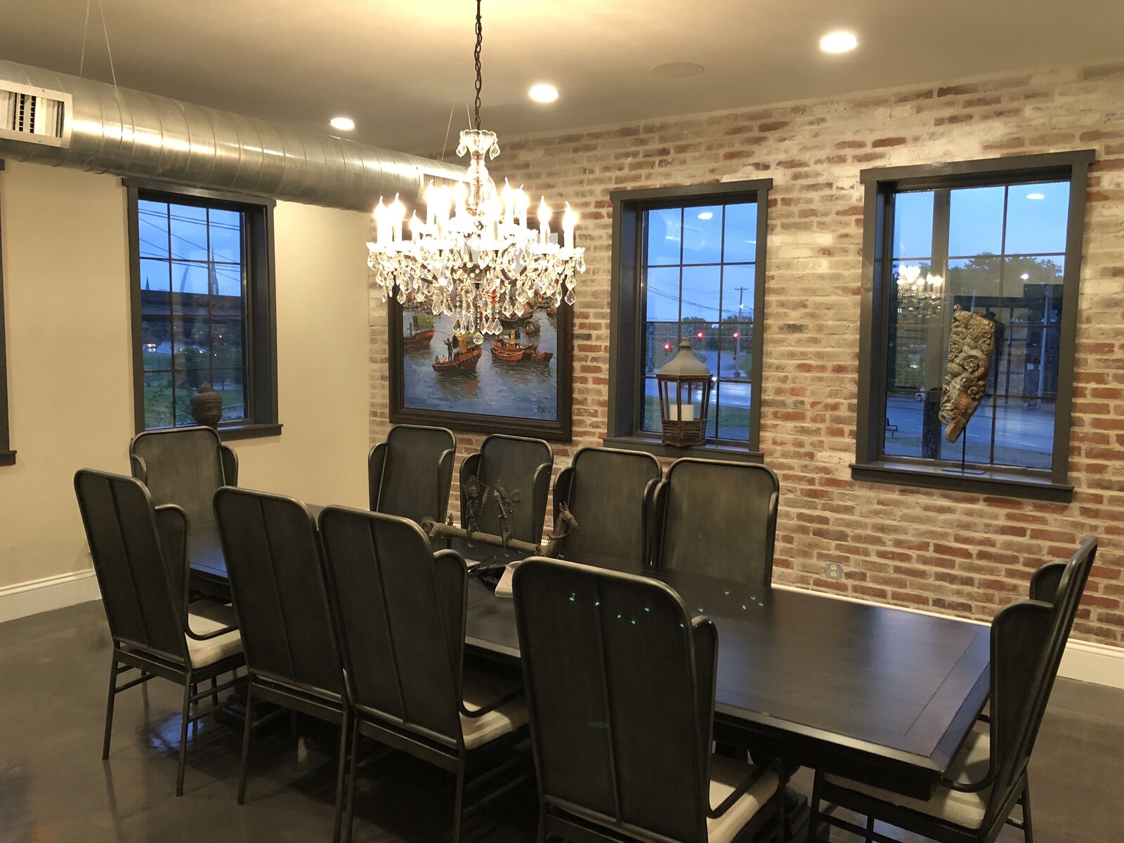 Executive conference room at THE 1301 with chandelier, exposed brick, and leather chairs