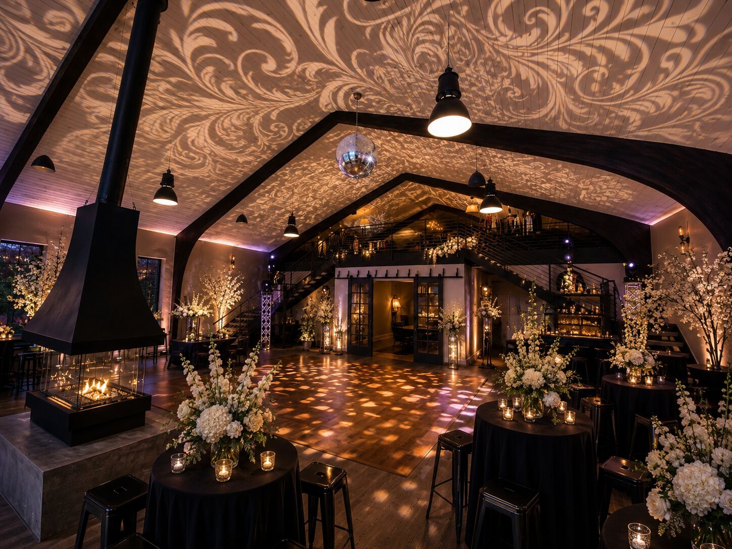 Evening dance floor at THE 1301 with patterned light projections on the vaulted ceiling