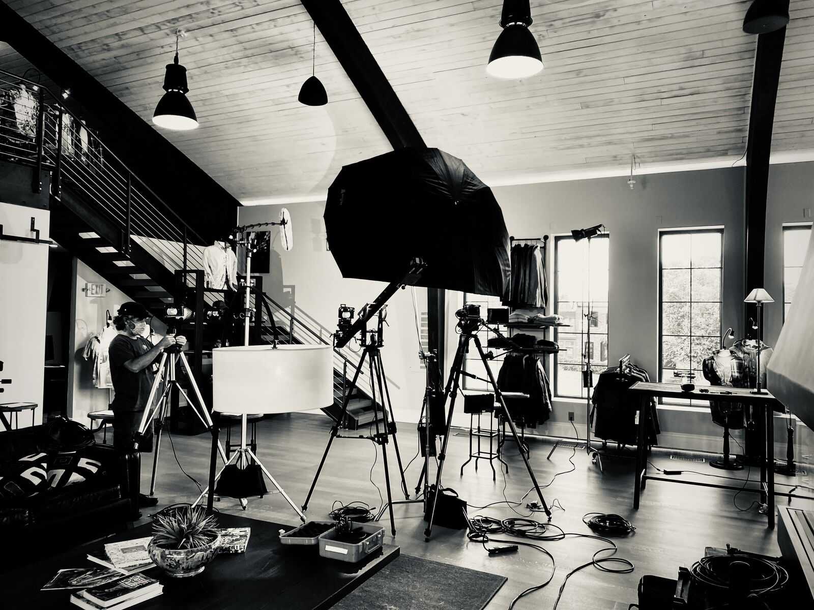 Film production crew and lighting rigs set up on the main floor of THE 1301
