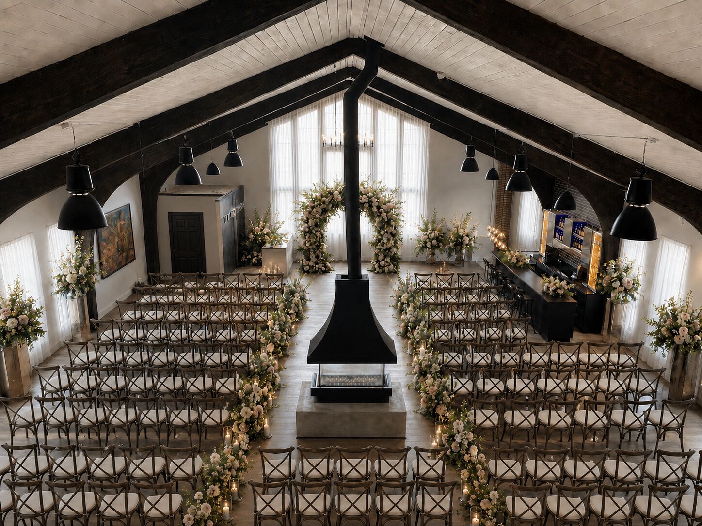 Wedding ceremony seating with floral-lined aisle under the vaulted ceiling at THE 1301